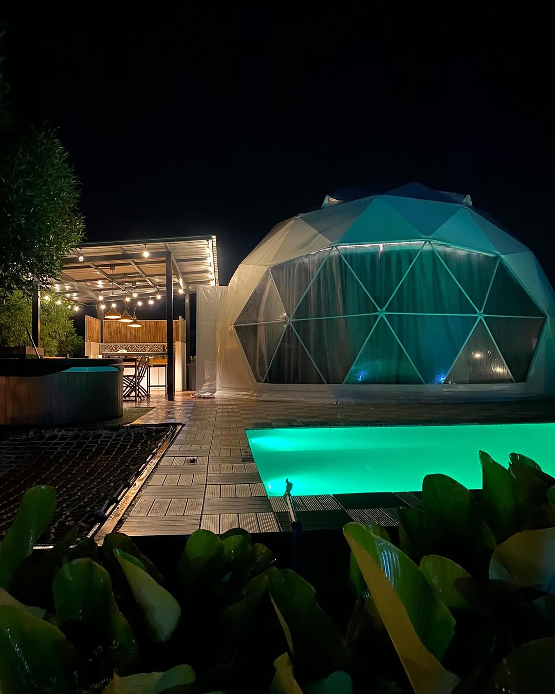 The Classic Dome illuminated at night with glowing pool